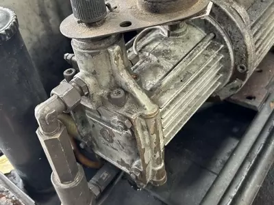 Original worn pump on a Kew 1502V hot pressure washer before full pump recondition and restoration.